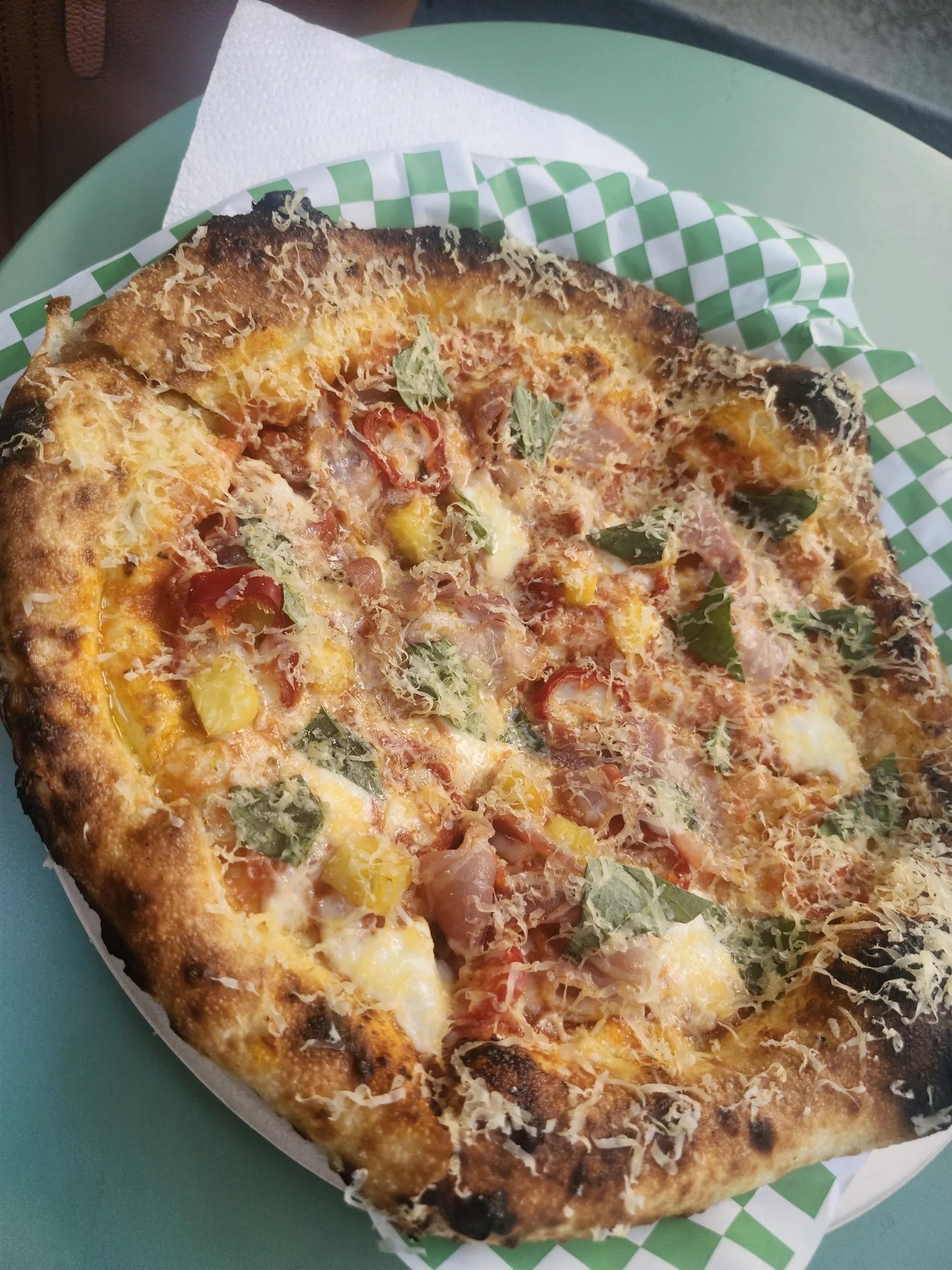 Burnt Mouth Pizza's pineapple pie with pancetta, pickled jalapeño, red sauce, mozzarella, aged gouda and basil
